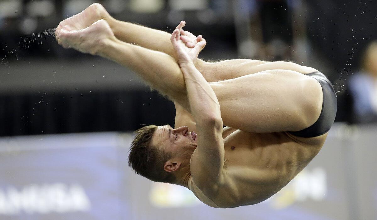 Troy Dumais dives during the men's 3-meter springboard semifinal at the U.S. Olympic diving trials on Monday, June 20, 2016, in Indianapolis. (AP Photo/