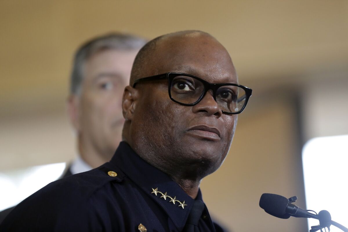 Dallas Police Chief David Brown, front, and Mayor Mike Rawlings take part in a news conference Friday after five officers were killed and more injured in an attack in downtown Dallas on Thursday night.