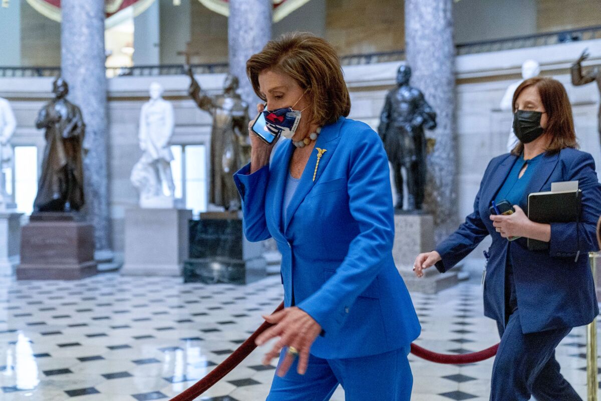 House Speaker Nancy Pelosi of Calif., walks towards the House Chamber to convene the House for legislative business at the Capitol in Washington, Tuesday, Oct. 12, 2021. The House is expected to vote to increase the debt limit later this afternoon. (AP Photo/Andrew Harnik)