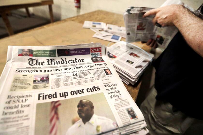 FILE- This Aug. 6, 2019 file photo shows The Vindicator newspaper prepared for delivery at the distribution center in Liberty Township near Youngstown, Ohio. The Vindicator in Youngstown, a 150-year-old paper that shut down last year because of financial struggles, is being celebrated in a new book on the anniversary of its final edition. "No Holds Barred" collects hundreds of columns by the paper's long-time political columnist, Bertram de Souza. It also features multiple historic photos and reminiscences by former writers and editors at the paper, whose closing, one of the biggest U.S. papers to disappear to date, left a hole in northeastern Ohio media coverage. (AP Photo/Tony Dejak, File)