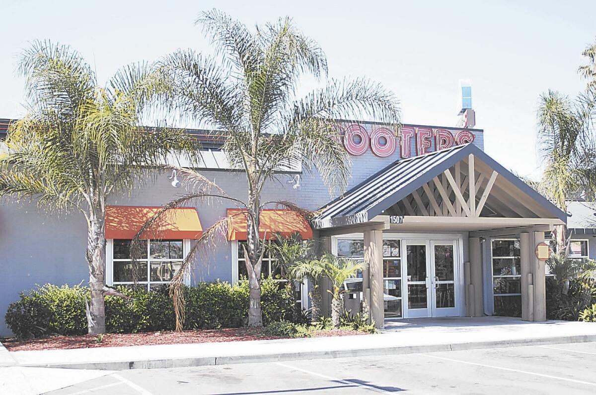 Two male former Hooters employees who were managers at the chain’s Costa Mesa restaurant, pictured, filed a sexual-harassment lawsuit against the company and the former chief executive of West Coast Hooters.