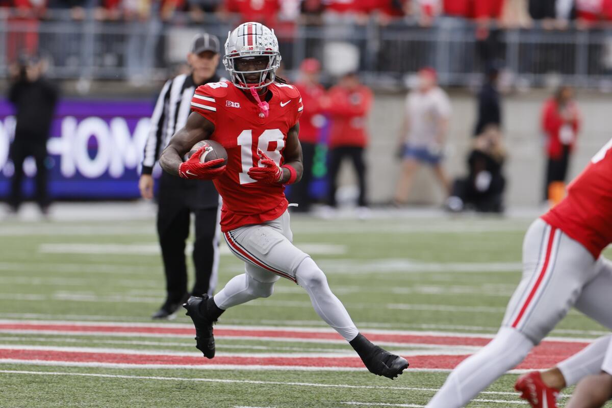 Ohio State receiver Marvin Harrison Jr. runs with the ball against Penn State.