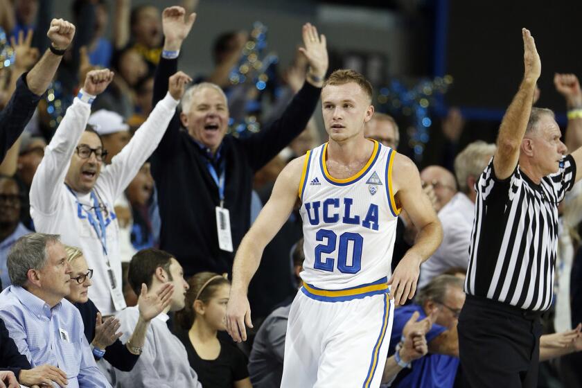 Fans celebrate after Bryce Alford made a three-pointer against Arizona at the end of the first half.