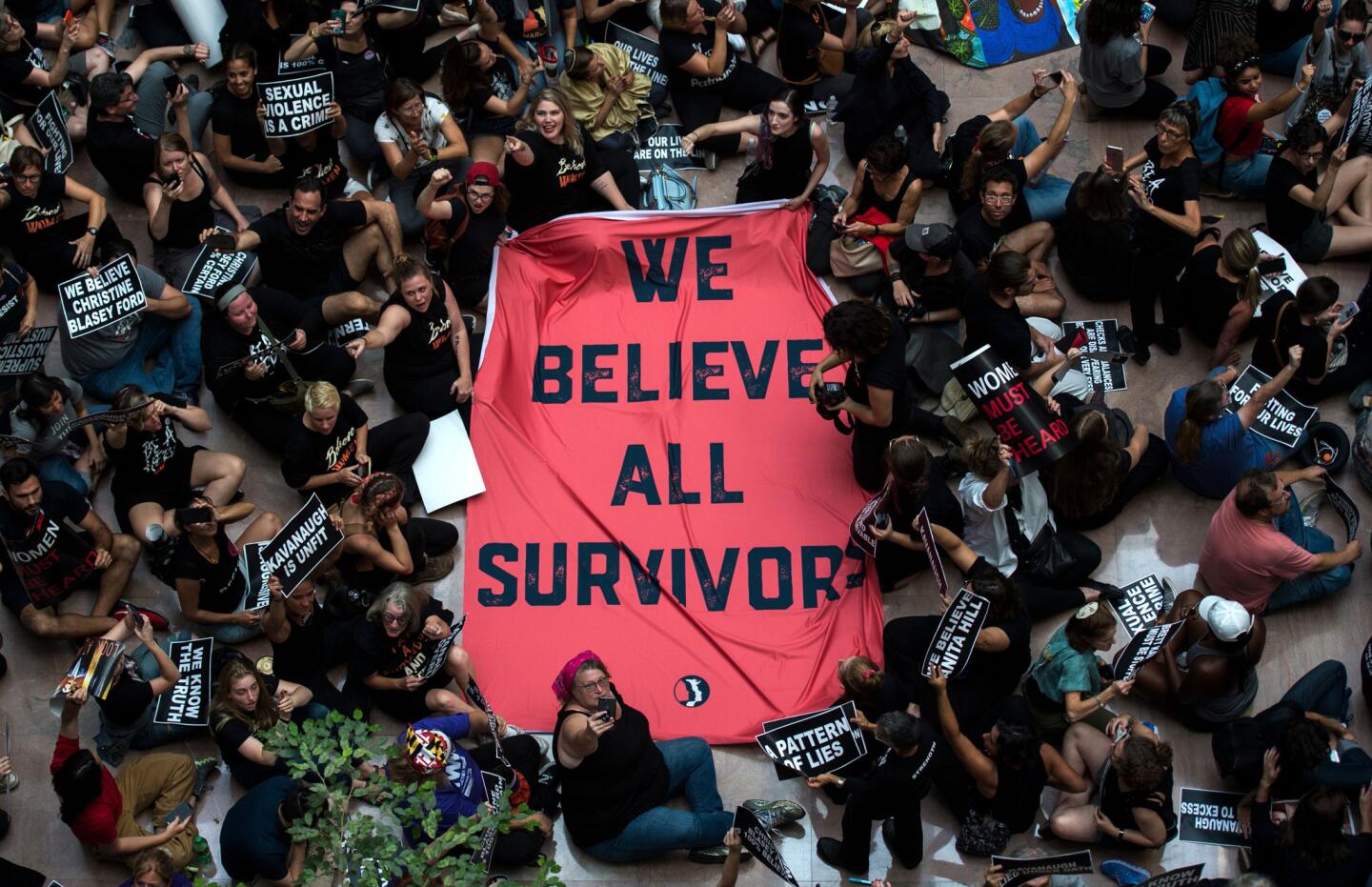 Protesters unfurl a sign as they occupy the Hart Senate Office Building during a rally against Supreme Court nominee Brett Kavanaugh on Capitol Hill.