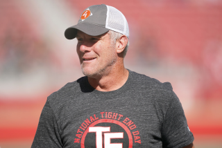 Former NFL quarterback Brett Favre wears a t-shirt that reads "National Tight End Day."