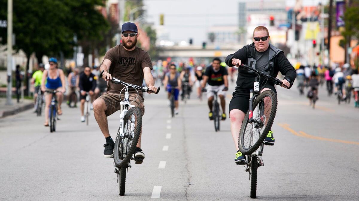 Cyclists perform wheelies as they ride down Lankershim Boulevard in Studio City for the CicLAvia bike festival on Sunday, March 22, 2015. For the first time, CicLAvia will take place in Glendale on Sunday.