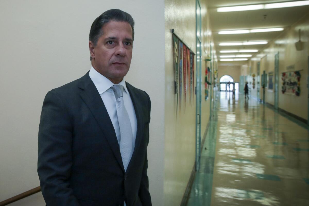 LAUSD Supt. Alberto Carvalho stands in a school hallway.