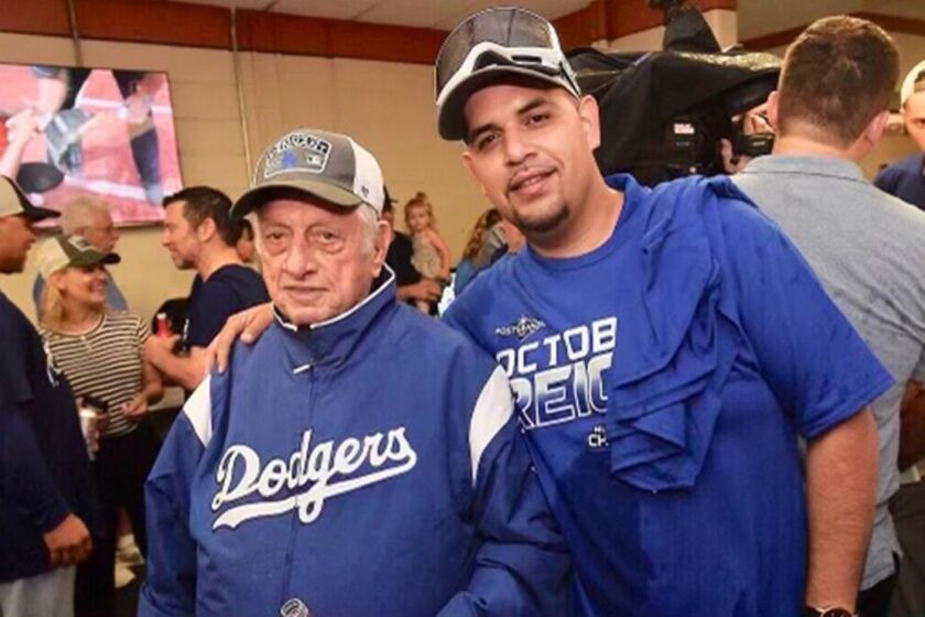 Former Dodger manager Tommy Lasorda with his driver, Felipe Ruiz.