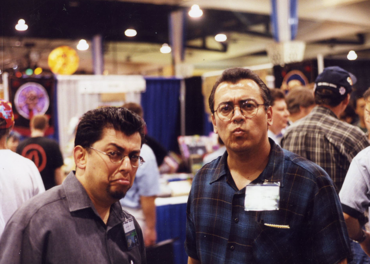 Two brothers making faces at the camera during a convention