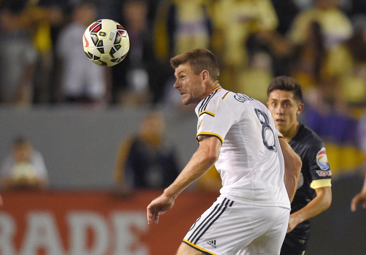 Steven Gerrard heads the ball away from Club America's Francisco Rivera during the first half of an exhibition game on Saturday night at StubHub Center.