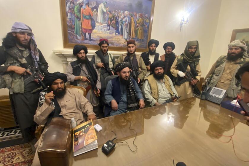 Taliban fighters take control of Afghan presidential palace after the Afghan President Ashraf Ghani fled the country, in Kabul, Afghanistan, Sunday, Aug. 15, 2021. (AP Photo/Zabi Karimi)