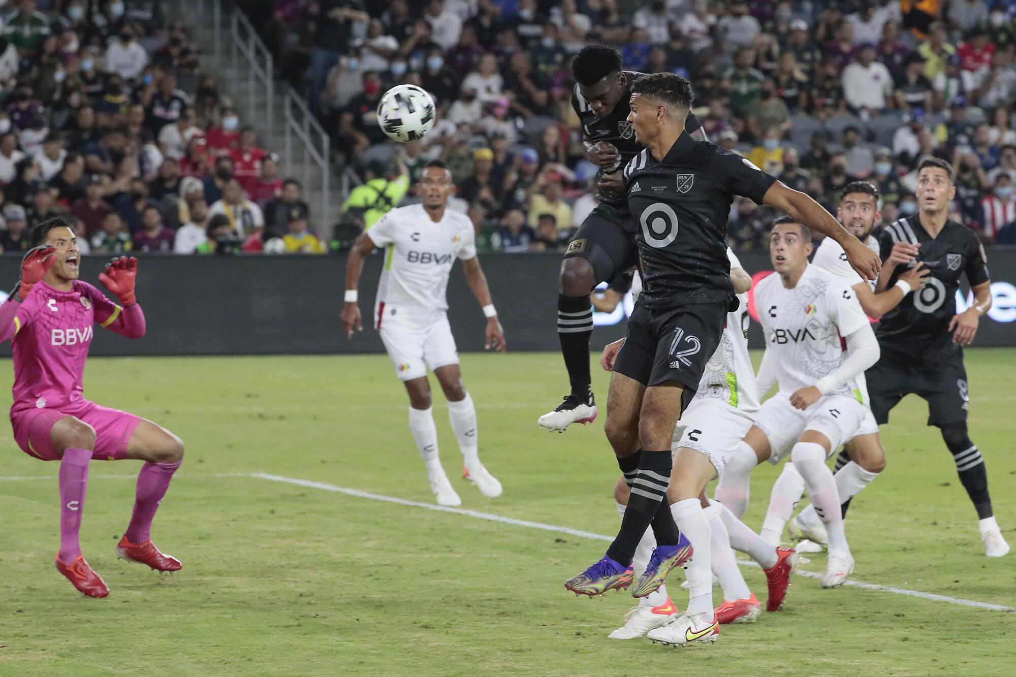 Jesus Murillo, behind Miles Robinson, 12, scores on a header past Liga MX goalie Alfredo Talavera