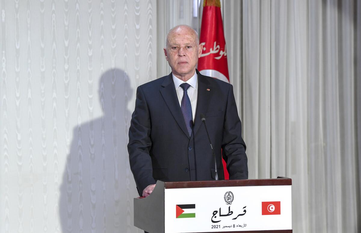 Tunisian President Kais Saied speaks at a lectern. 