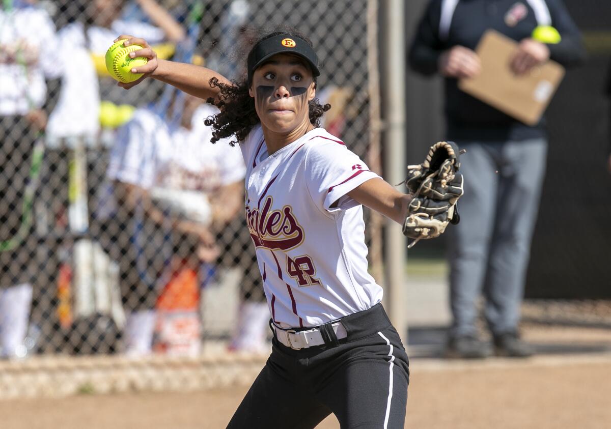 Estancia's Jaydin McClure throws to first in an attempt to throw out Costa Mesa's Sydnie Pulido on Wednesday.