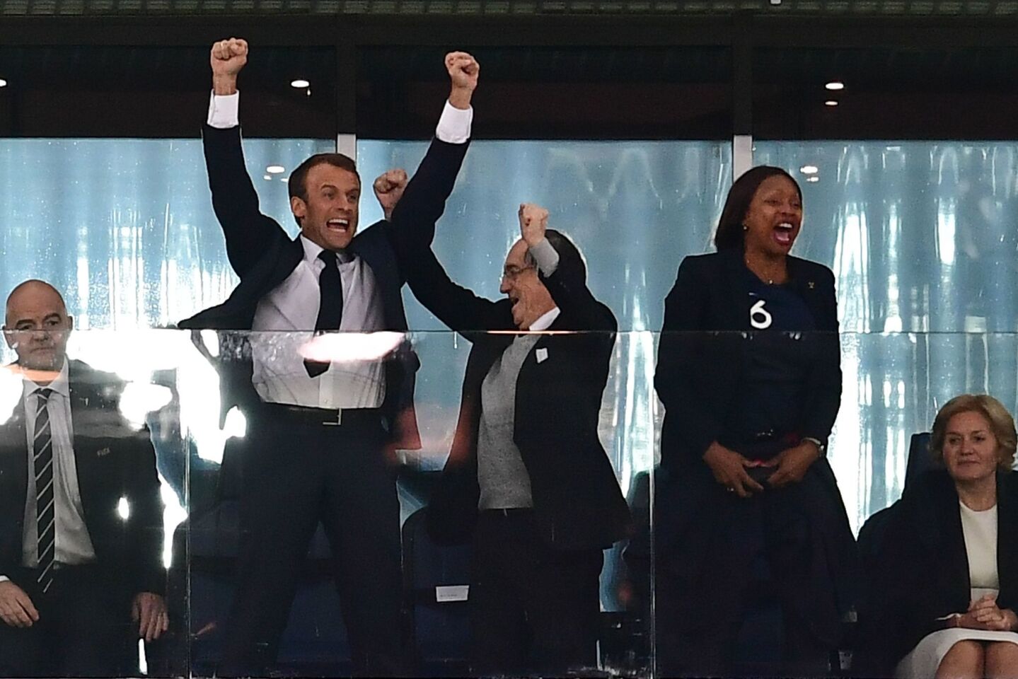 French President Emmanuel Macron, left, celebrates alongside French Football Federation President Noel Le Graet, center, and French Sports Minister Laura Flessel at the end of Tuesday's World Cup match.
