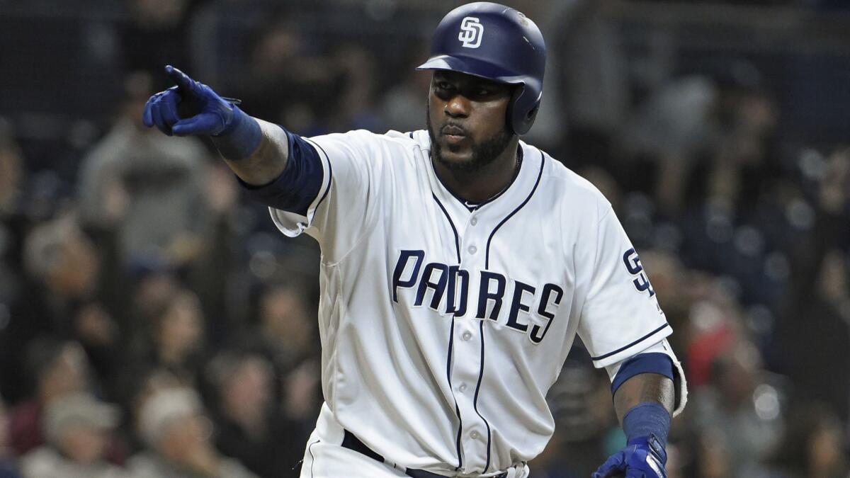 The Padres' Franmil Reyes points to the dugout after hitting a two-run home run during the sixth inning of a baseball game against the Miami Marlins at Petco Park on May 29, 2018 in San Diego, California.