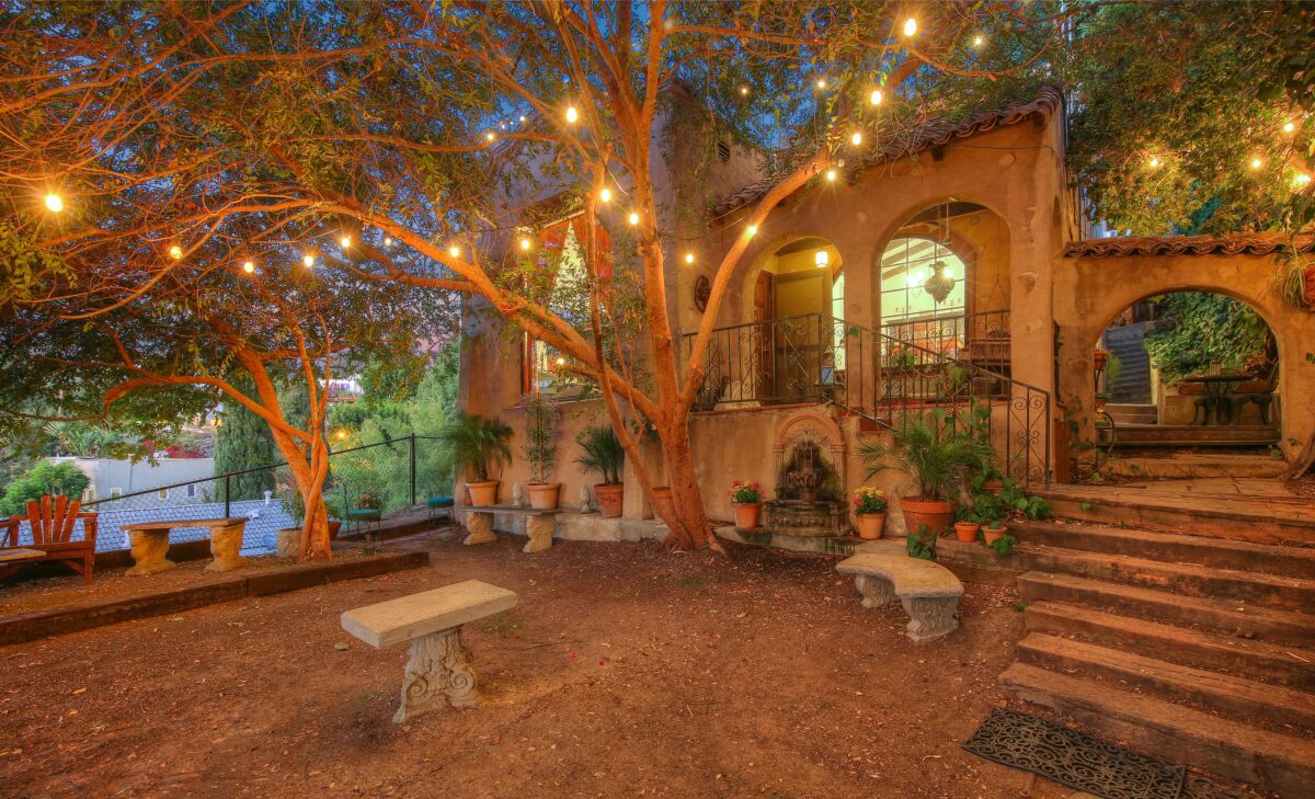 Andy Paley's Los Feliz home features a tree-covered courtyard under string lights.