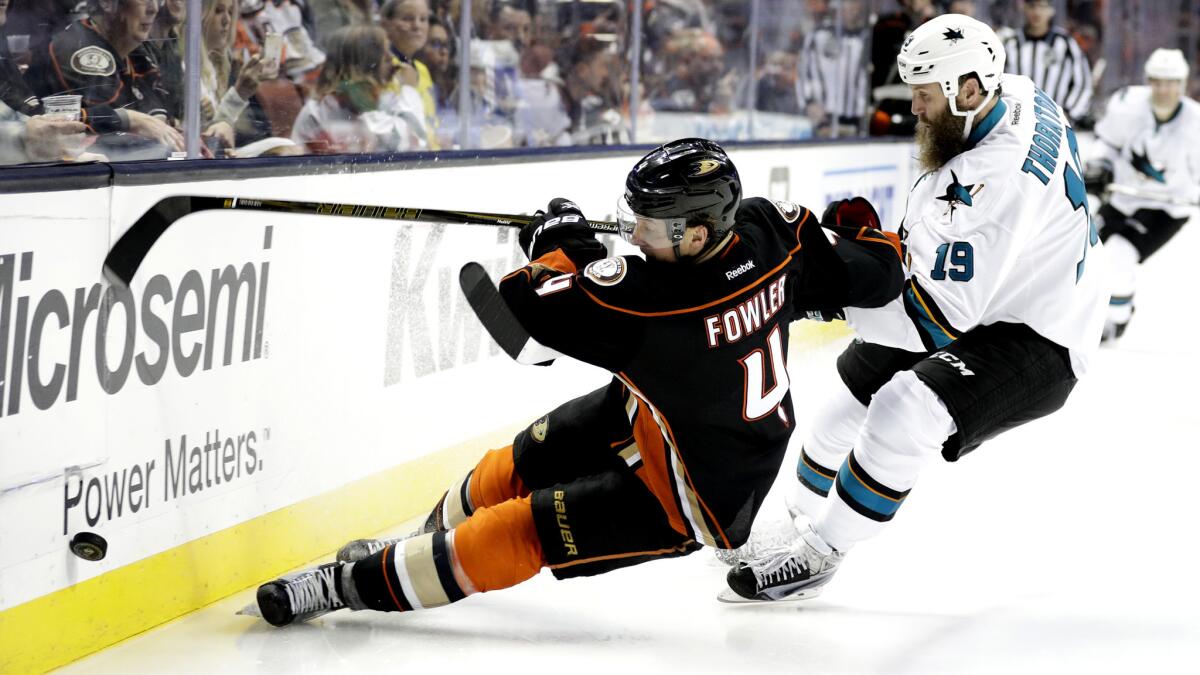 Ducks defenseman Cam Fowler beats Sharks center Joe Thornton to the puck during a game last season.
