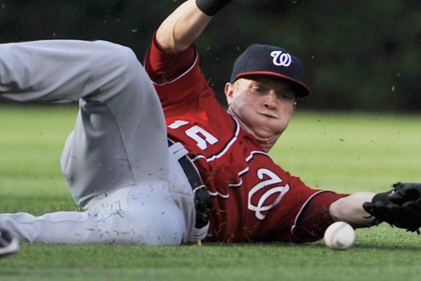 Washington Nationals center fielder Nate McLouth fails to make a catch during a game against the Chicago Cubs in June. A shoulder injury will sideline McLouth for the remainder of the season.