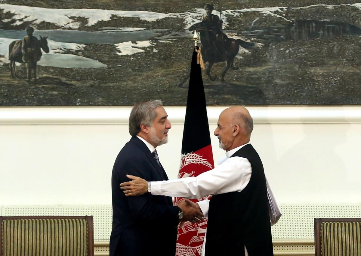 Afghanistan presidential election candidates Abdullah Abdullah, left, and Ashraf Ghani Ahmadzai shake hands after signing a power-sharing deal in Kabul.