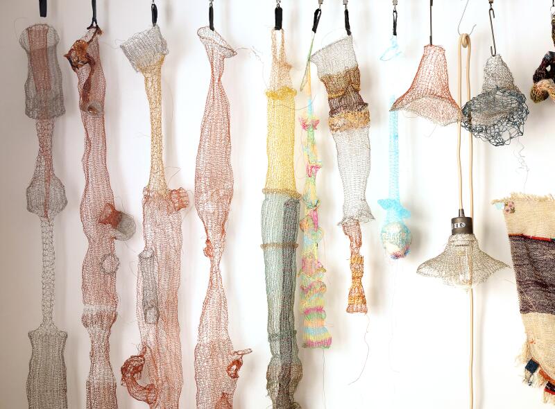 Metal sculptures with a hand hanging on a wall