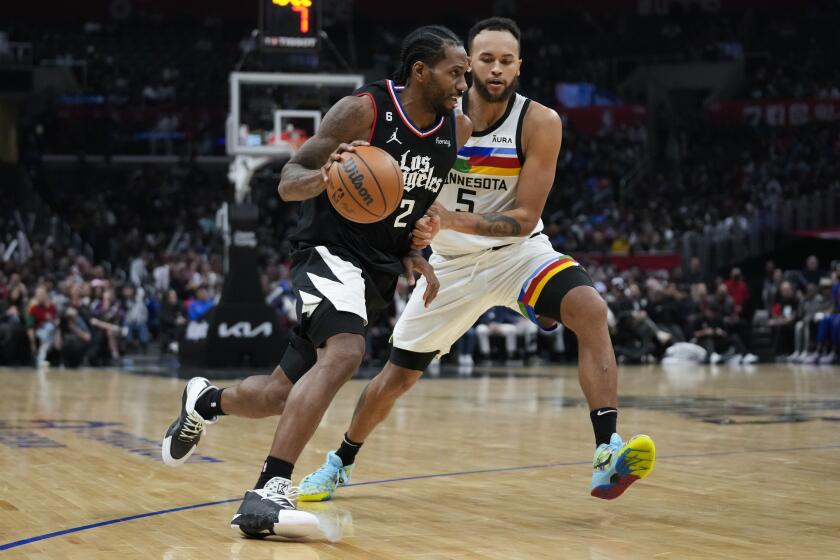 Minnesota Timberwolves forward Kyle Anderson (5) defends against Los Angeles Clippers forward Kawhi Leonard (2) during the second half of an NBA basketball game in Los Angeles, Wednesday, Dec. 14, 2022. (AP Photo/Ashley Landis)
