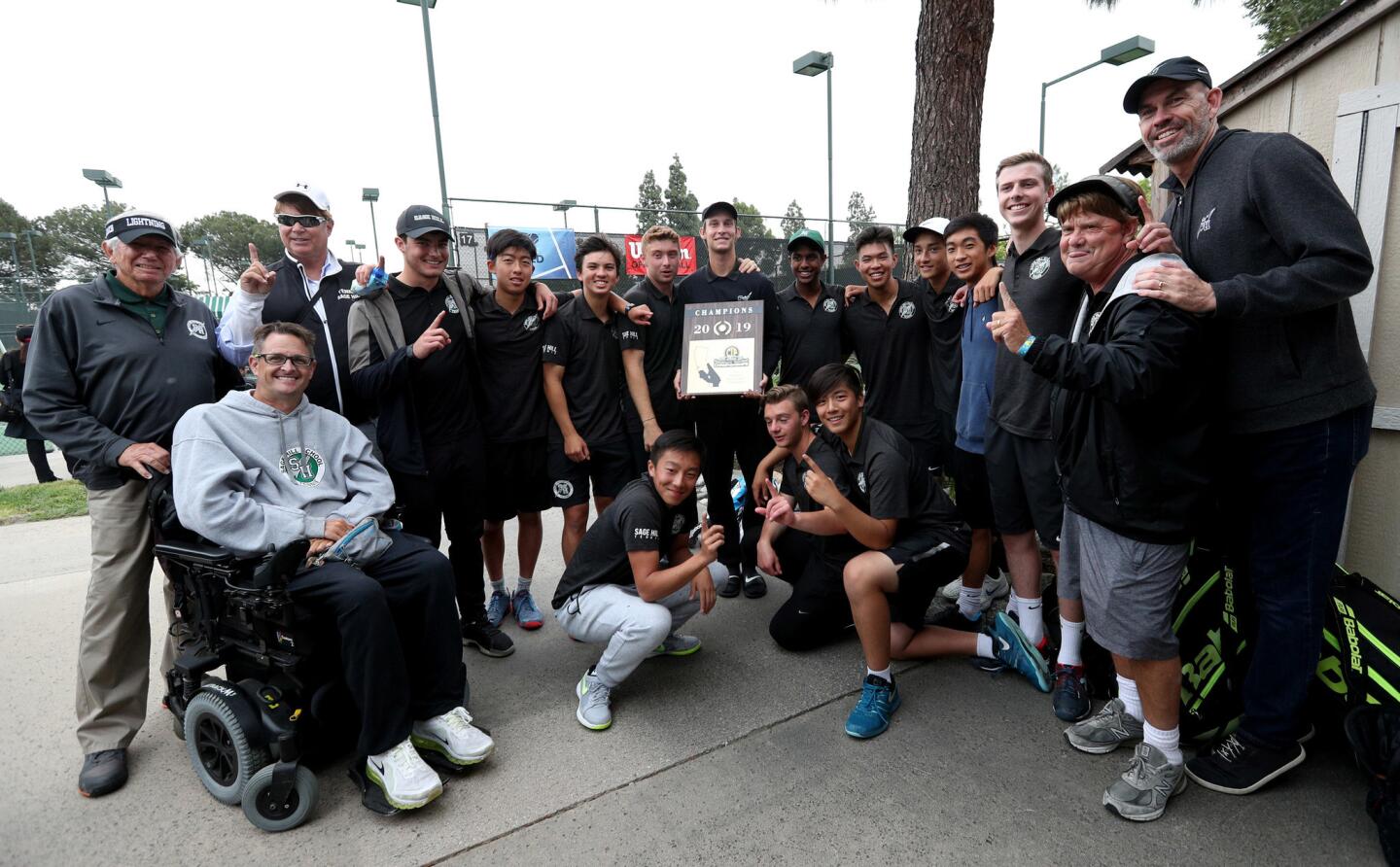 The Sage Hill School boys' tennis team and coaching staff celebrate after winning the CIF Southern Section Division 1 championship against Beckman at the Claremont Club in Claremont on Friday.