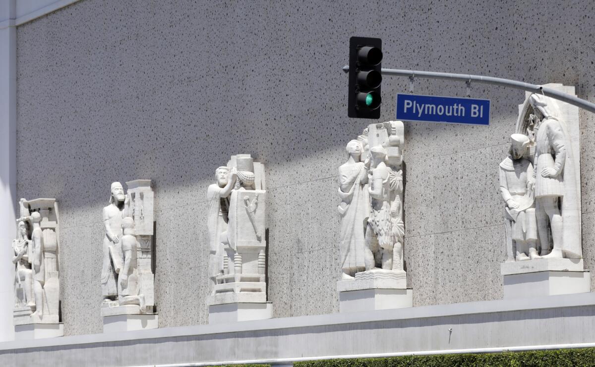 Sculptures of historic figures front the Scottish Rite Masonic Temple.