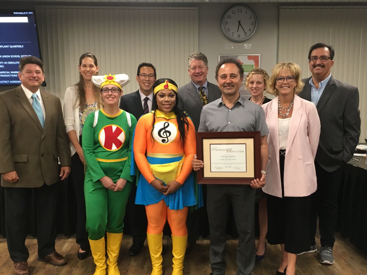 Del Mar Union School District has teamed up with The Super Dentists on a new corporate partnership. Dr. Kami Hoss is seen here with The Tooth Keri and Melo-D and DMUSD board members Scott Wooden, Katherine Fitzpatrick, Gee Wah Mok, Doug Rafner, Erica Halpern, Assistant Superintendent Jason Romero and Superintendent Holly McClurg.