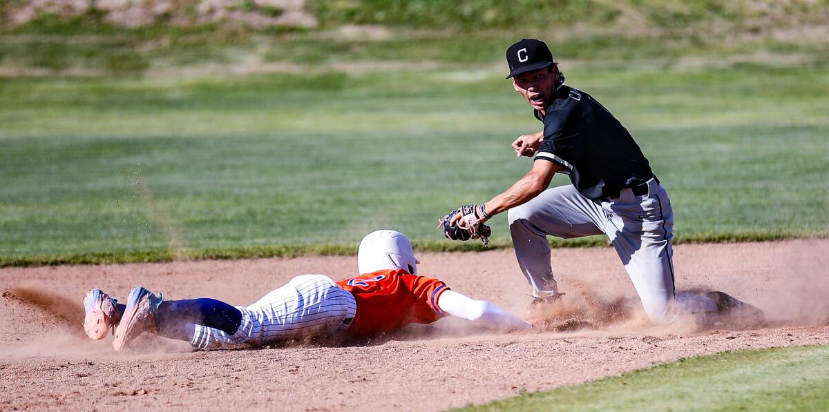 Calabasas shortstop Nathan Castellon tries to get pickoff of Westlake's Noah Stead.