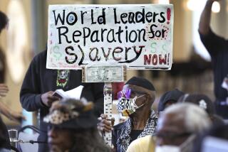 Los Angeles, California-Sept. 22, 2022-Los Angeles long-time resident, Walter Foster, age 80, holds up a sign as the Reparations Task Force meets to hear public input on reparations at the California Science Center in Los Angeles on Sept. 22, 2022. (Carolyn Cole / Los Angeles Times)