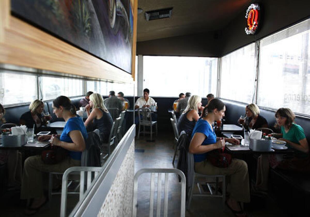CASUAL: The interior of Blue Star offers a simple dining room with windows looking out to the patio.