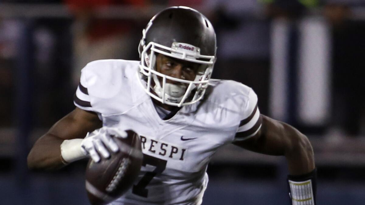 Crespi's Marvel Tell carries the ball on a fake field-goal attempt during a 48-20 win over Sherman Oaks Notre Dame on Oct. 17, 2014.