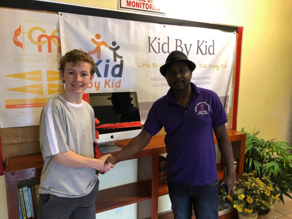 Kid by Kid founder Daxton Gutekunst greets pastor Jean Elise Durandisse of the Haitian Ministry of San Diego.