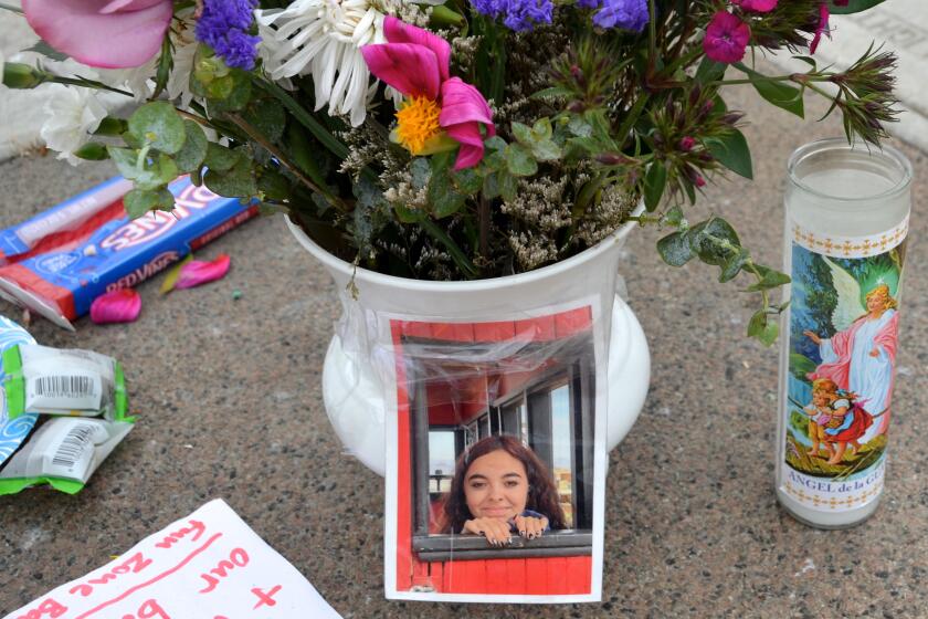 A photo of 14-year-old Rosenda Elizabeth Smiley, of Rialto, in a roadside memorial near Balboa Boulevard at Palm Street.
