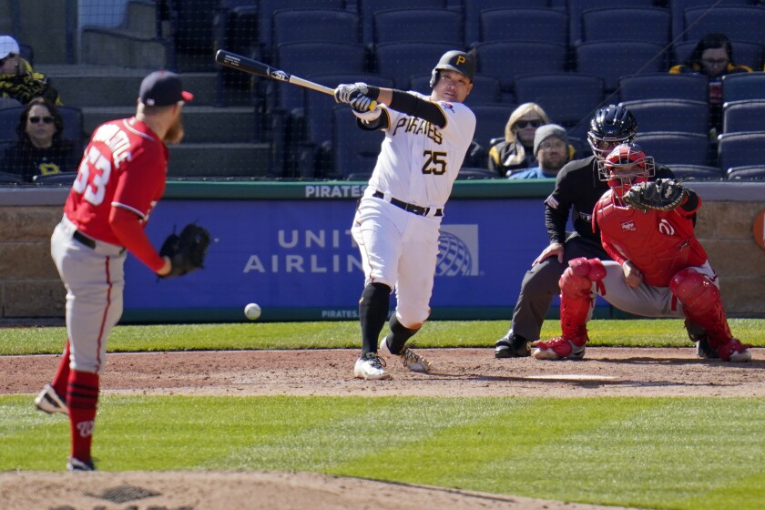 Pittsburgh Pirates' Yoshi Tsutsugo (25) drives in a run with a fielder's choice off Washington Nationals relief pitcher Sean Doolittle (63) during the seventh inning of a baseball game in Pittsburgh, Sunday, April 17, 2022. Catching is Riley Adams. (AP Photo/Gene J. Puskar)