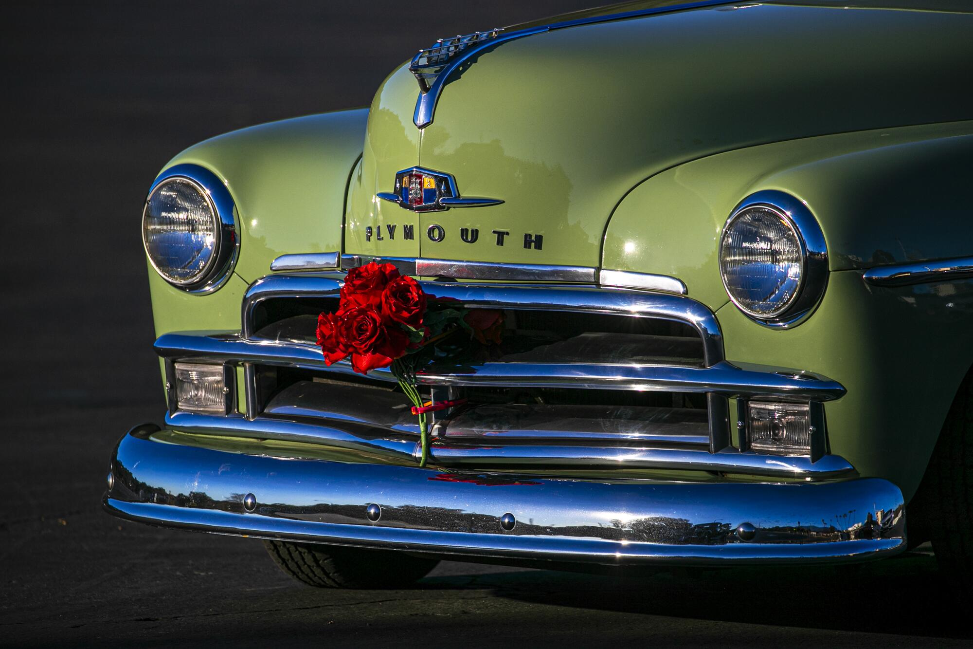 Sultans Car Club of Long Beach decorated their classic cars with roses before driving down Colorado Boulevard.