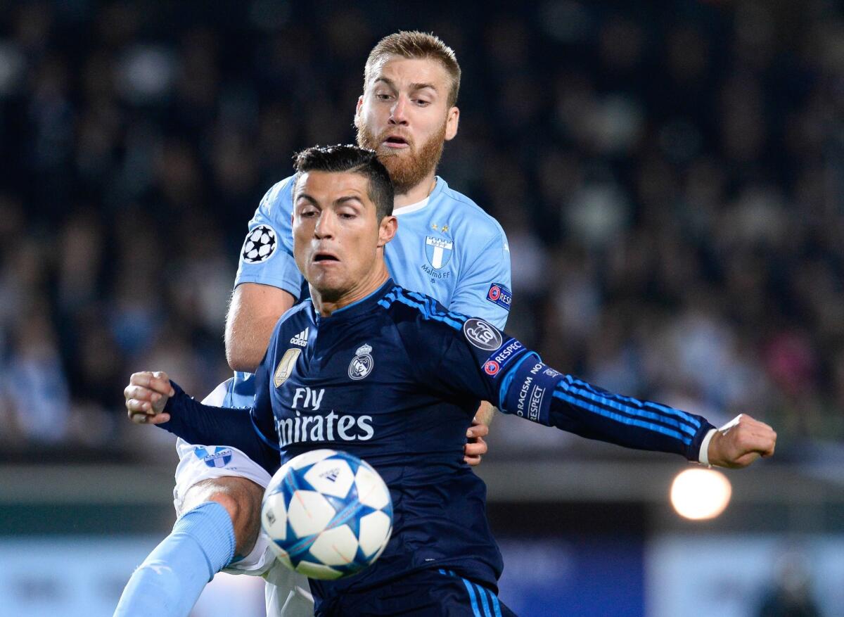 Real Madrid's Portuguese forward Cristiano Ronaldo (R) and Malmo's Norwegian midfielder Jo Inge Berget vie for the ball during the UEFA Champions League first-leg Group A football match between Malmo FF and Real Madrid CF at the Swedbank Stadion, in Malmo, Sweden on September 30, 2015. AFP PHOTO / JONATHAN NACKSTRANDJONATHAN NACKSTRAND/AFP/Getty Images ** OUTS - ELSENT, FPG, CM - OUTS * NM, PH, VA if sourced by CT, LA or MoD **