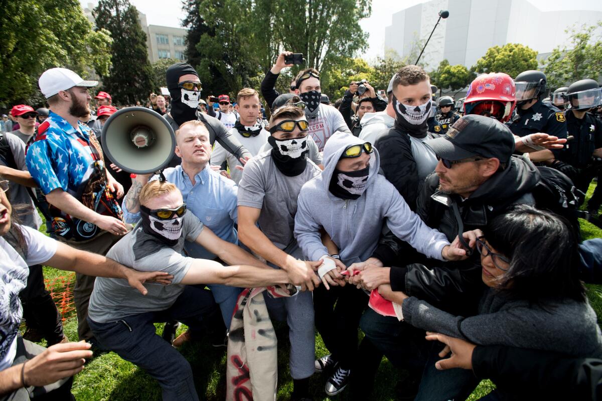 Members of the so-called Rise Above Movement face off with counter-protesters during a rally in Berkeley on April 15, 2017.