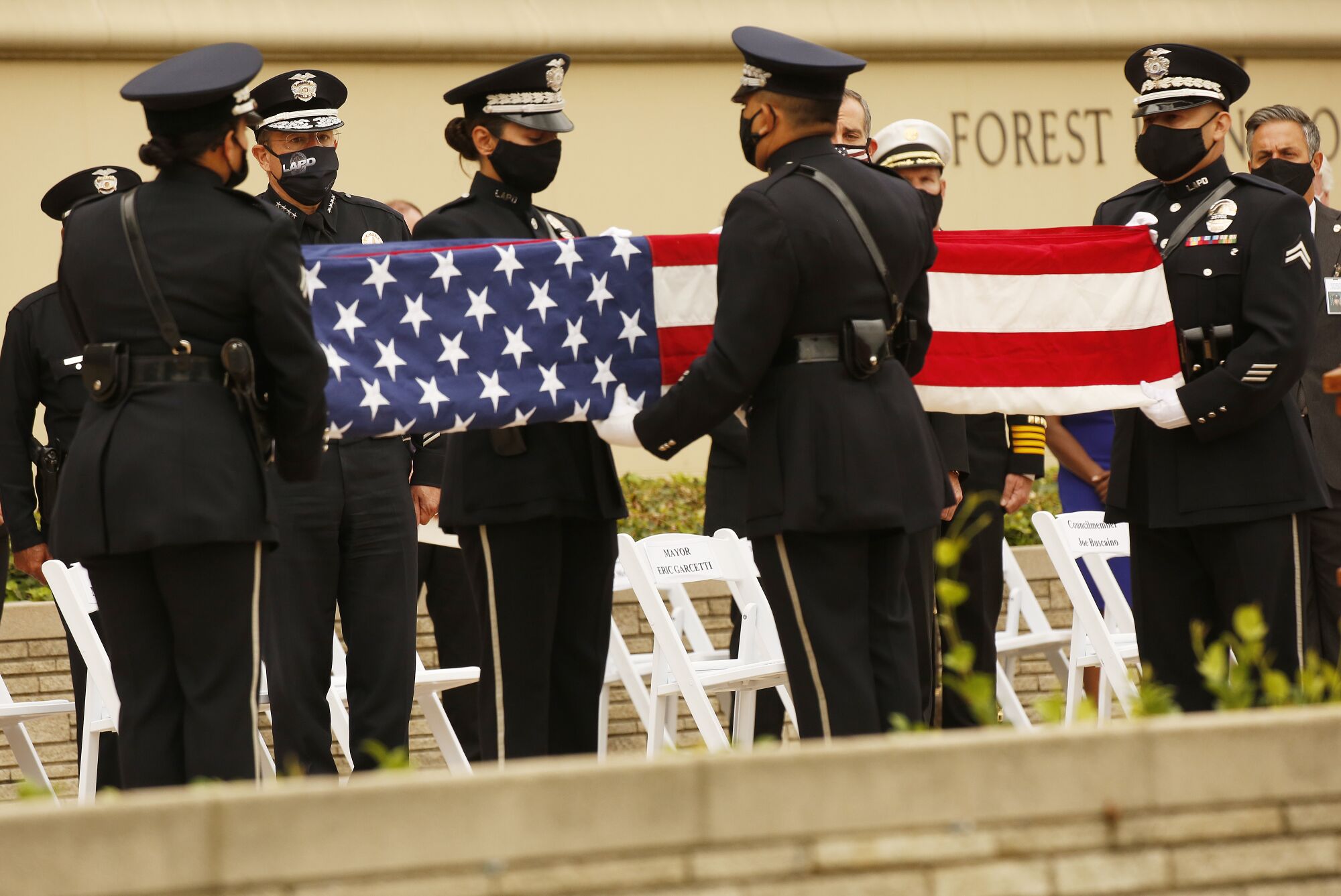 A flag honoring Officer Valentin Martinez is folded. 
