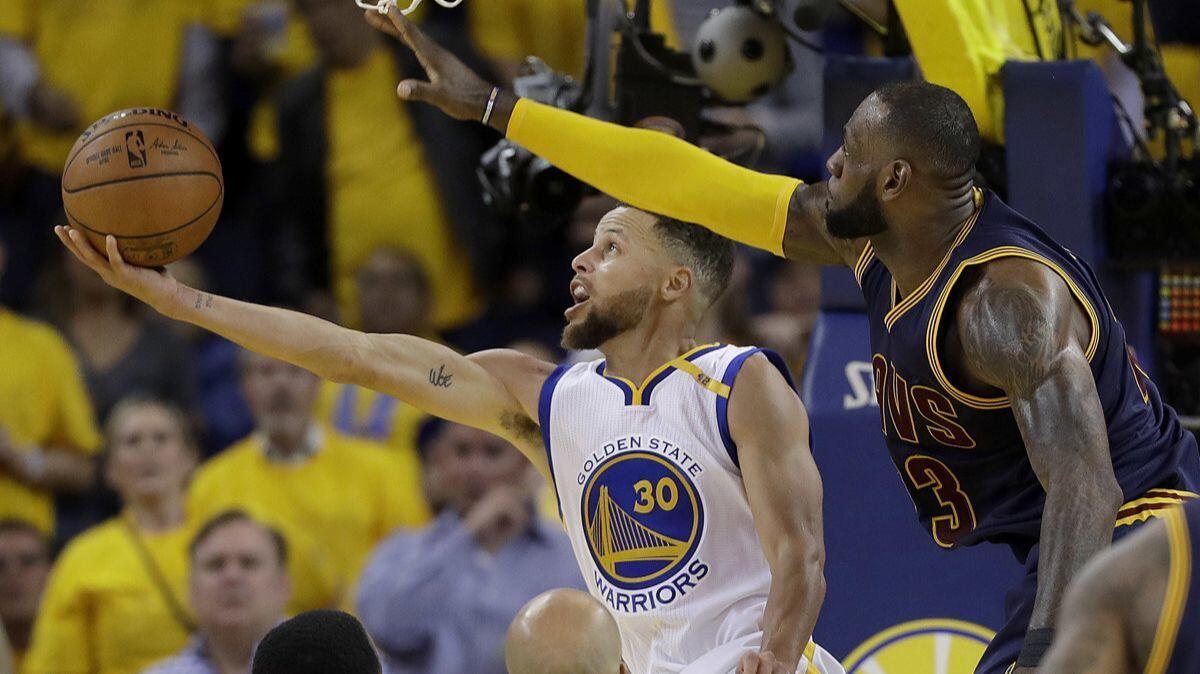 Golden State Warriors guard Stephen Curry shoots against Cleveland Cavaliers forward LeBron James during the second half of Game 1 of the NBA Finals on June 1, 2017.