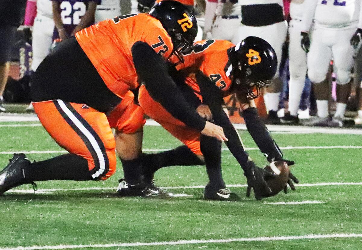 Los Amigos' Aaron Barba (72) and Rocco Rivera (43) reach for a loose ball against Santiago on Thursday.