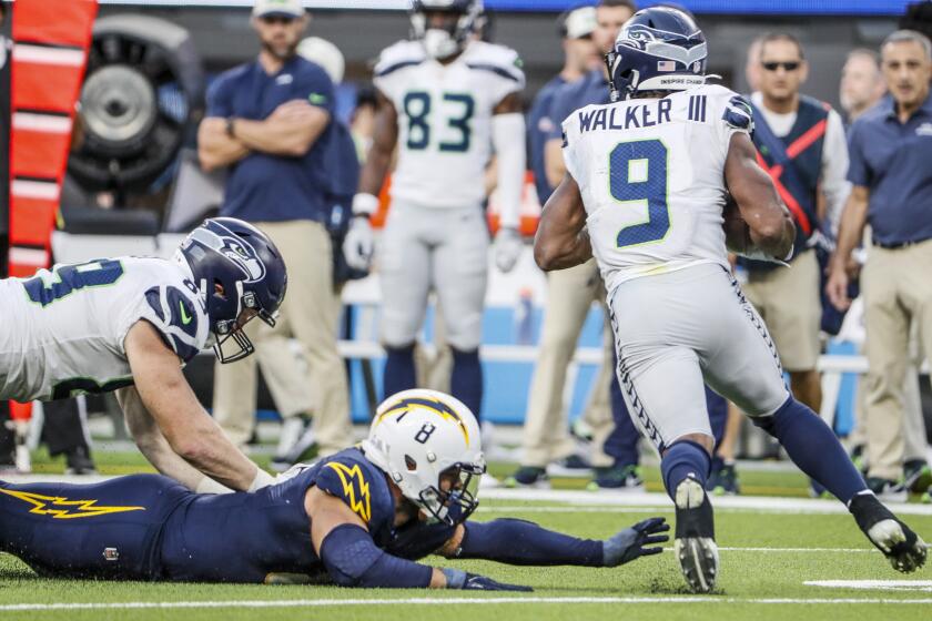 Inglewood, CA, Sunday, October 23, 2022 - Los Angeles Chargers linebacker Kyle Van Noy (8) falls short of tackling Seattle Seahawks running back Kenneth Walker III (9) as he breaks free for a long touchdown run late in the game at SoFi Stadium. (Robert Gauthier/Los Angeles Times)