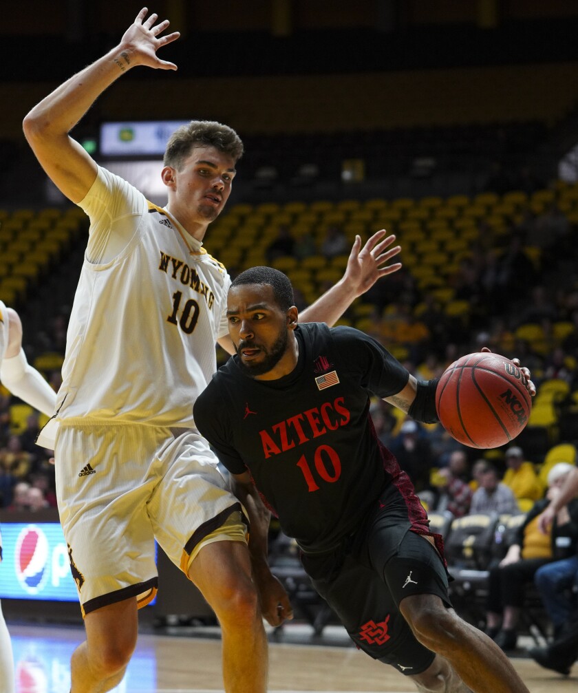 San Diego State guard KJ Feagin attempts to drive past Wyoming forward Hunter Thompson during Wednesday's game in Laramie, Wyo.