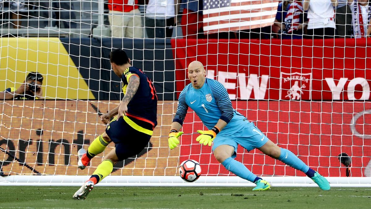 Colombia forward James Rodriguez slips a penalty kick past U.S. goalkeeper Brad Guzan in the first half Friday.