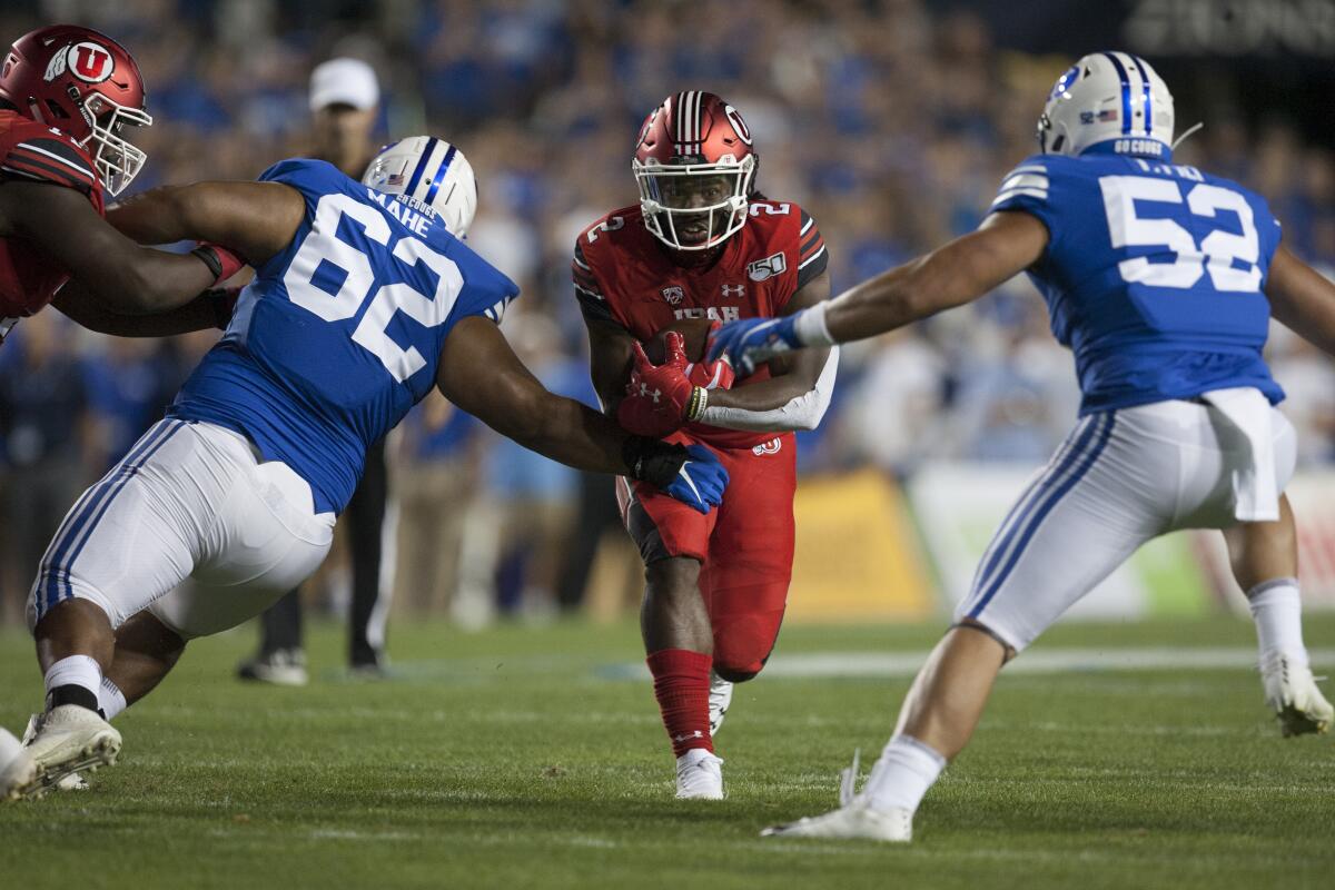 Utah running back Zack Moss carries the ball against BYU on Aug. 29.