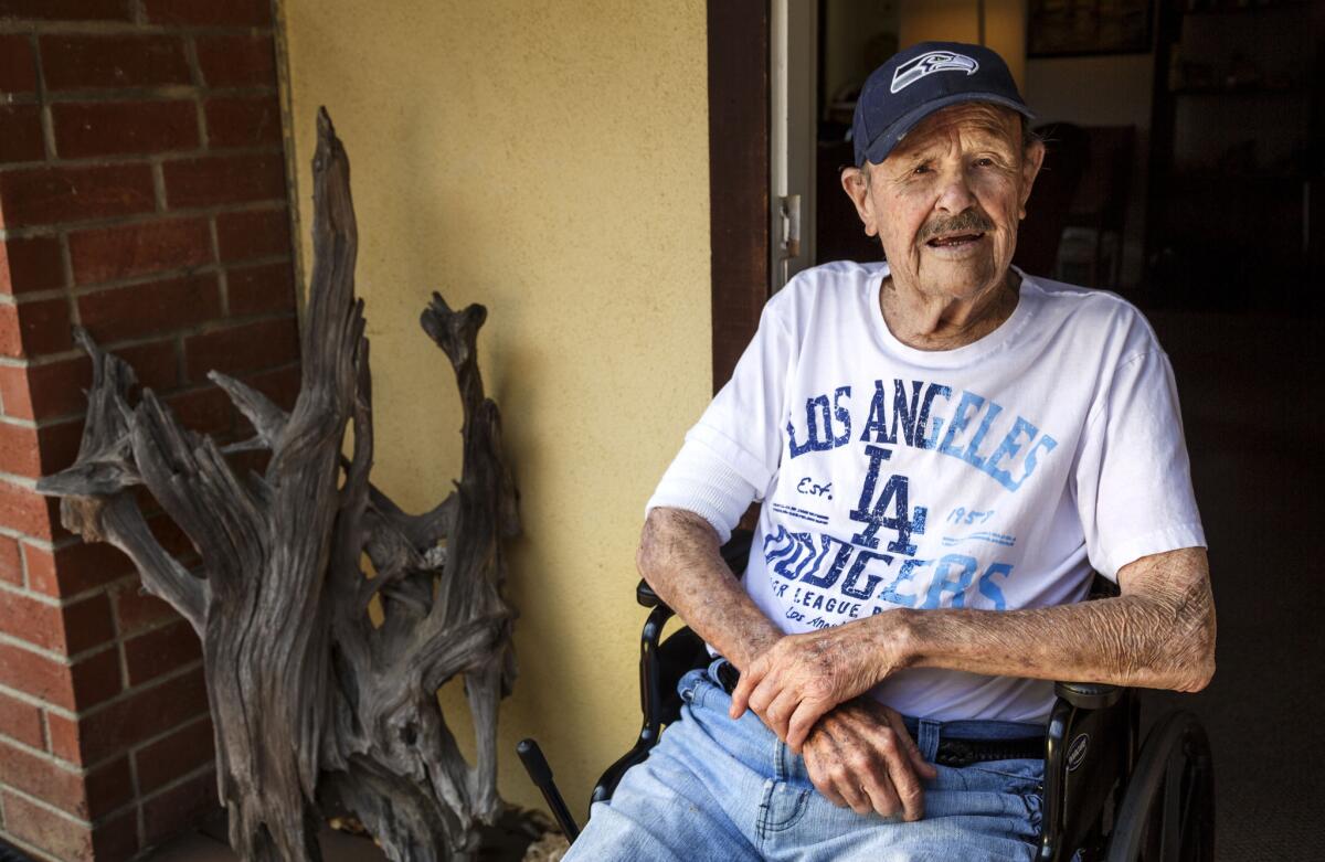 Jim Ballard, a 94-year-old World War II veteran, sits at his Carpinteria home where he's facing another season in which he'll be unable to watch the Dodgers, his favorite team, on television.