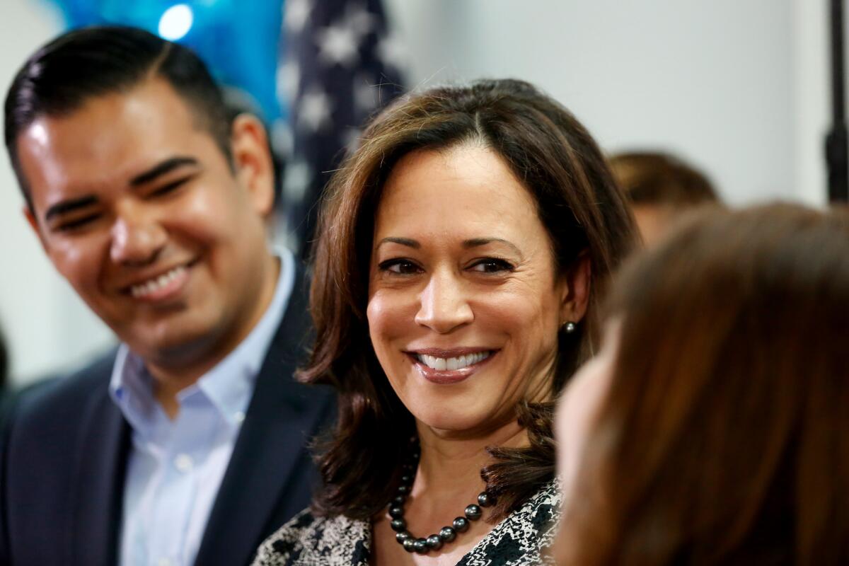 Senator-elect Kamala Harris, center, speaks with Long Beack Mayor Robert Garcia, left, and Angelica Salas of the Coalition for Humane Immigration Rights of Los Angeles during a meeting with immigrant families and activists on Nov. 10.
