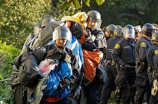 Police in riot gear remove tents in front of Sproul Hall at UC Berkeley on Wednesday.