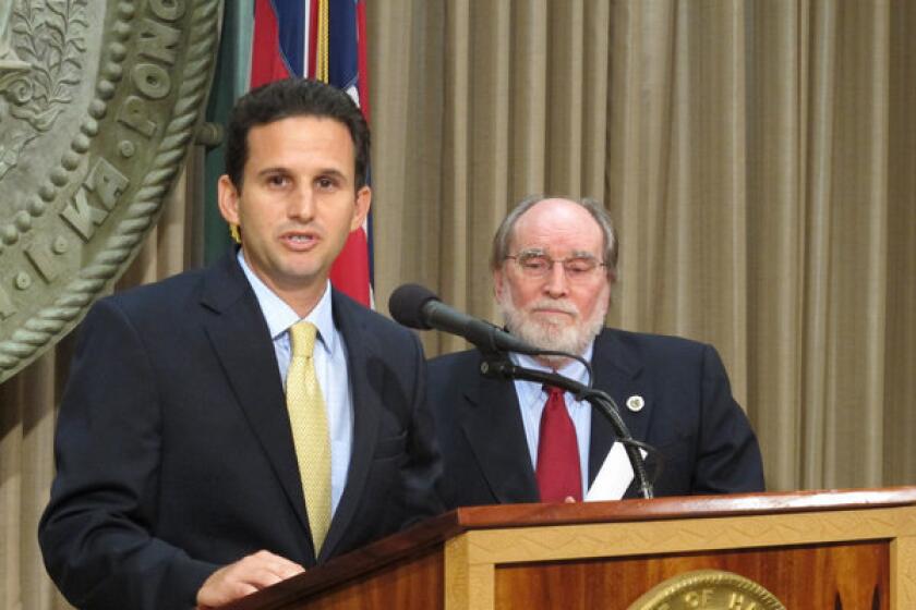 Hawaii Lt. Gov. Brian Schatz speaks at the state Capitol in Honolulu on Wednesday after Gov. Neil Abercrombie, right, announced he was appointing Schatz to fill the seat vacated by the late U.S. Sen. Daniel K. Inouye.
